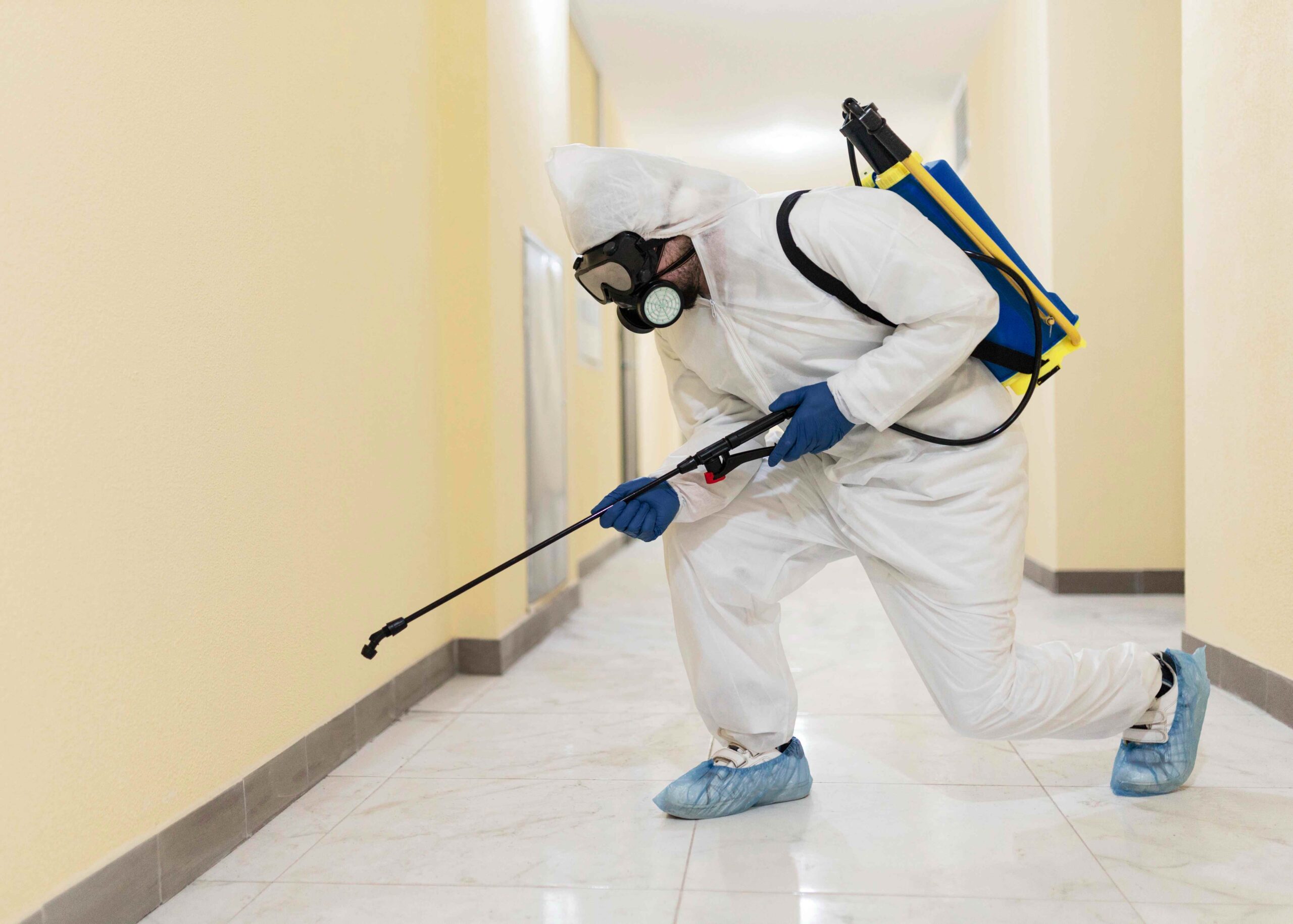 full-shot-man-disinfecting-building-compressed