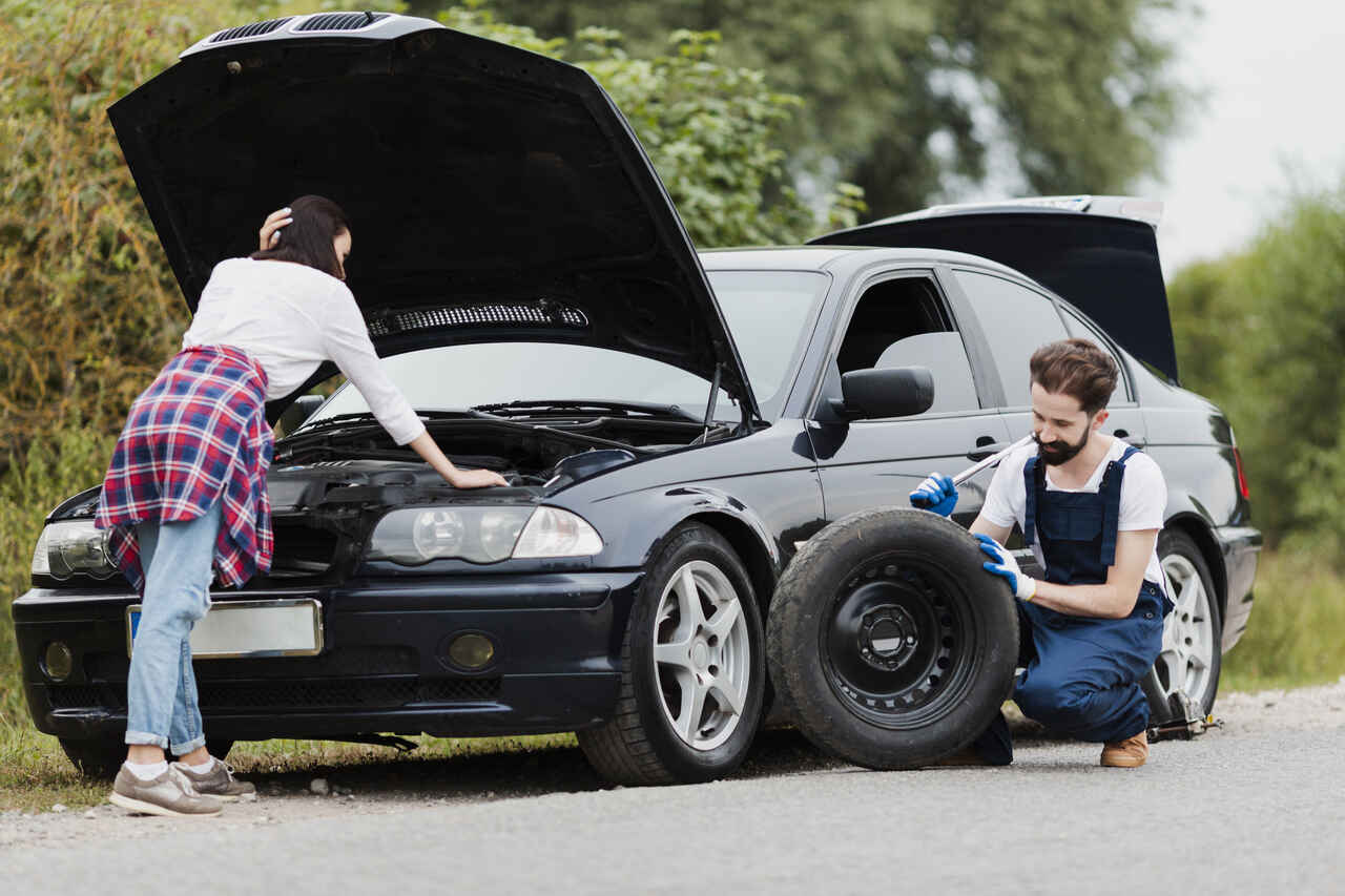 woman-checking-engine-man-changing-tyre_Easy-Resize.com_Easy-Resize.com (1)